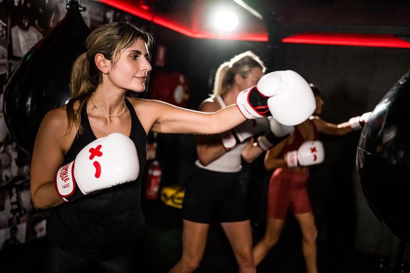 woman wokring out in a group fitness class at Rumble boxing