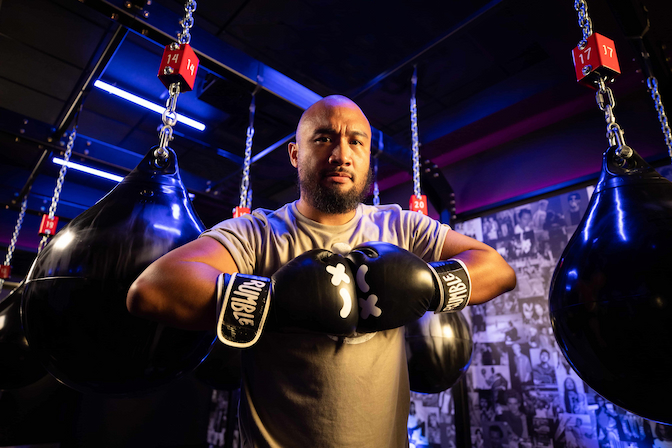 man holding his boxing gloves together to practice breathing