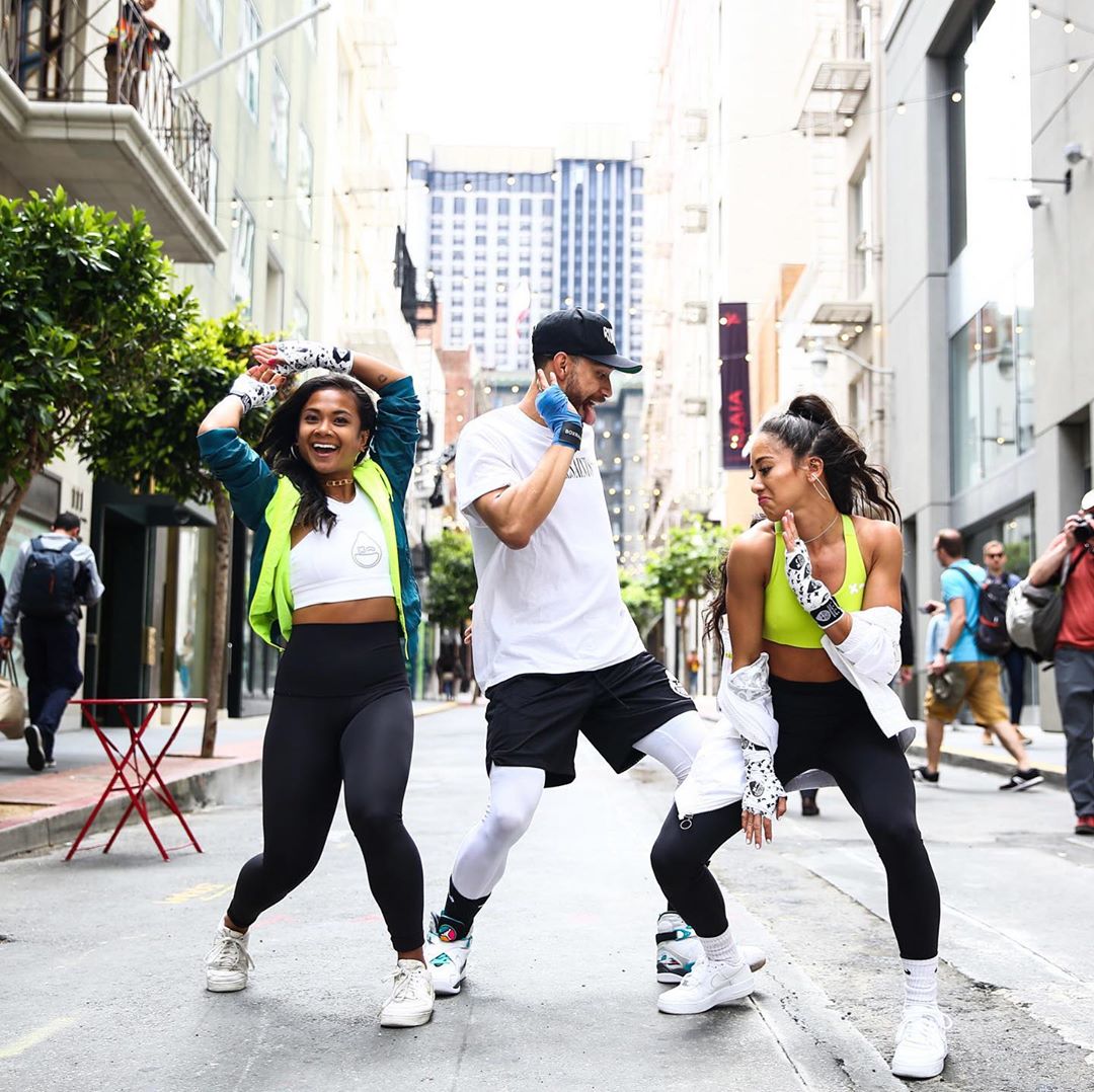 group of fitness boxers in fitness attire dancing in street