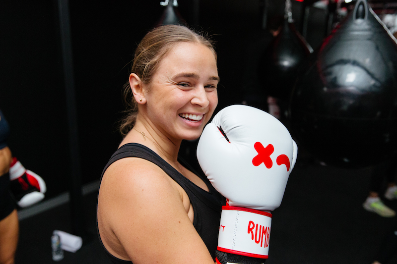 smiling woman with white boxing gloves